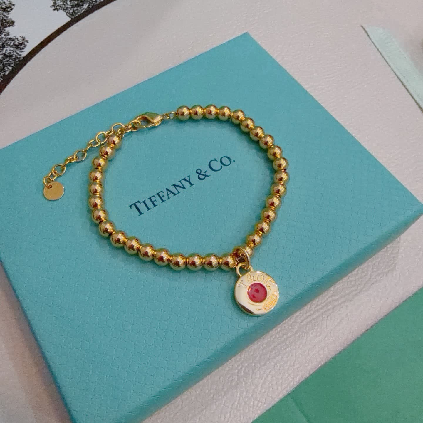 Tiffany & Co. Gold Bead Bracelet with Red Enamel Charm